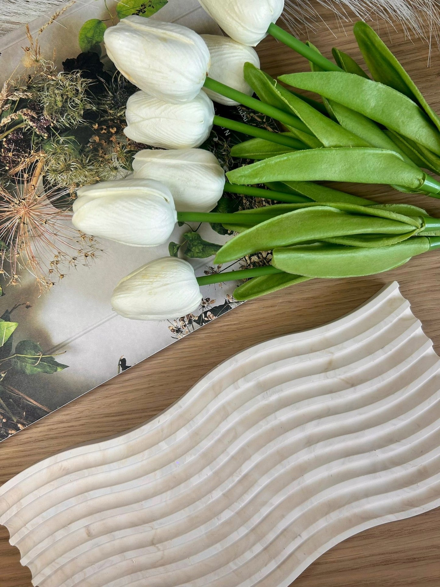 Ripple-effect tray in soft marbled Jesmonite, styled with ivory tulips and botanical photography – elegant handmade decor piece.