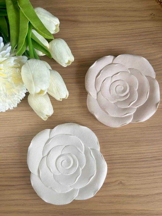Pair of handmade flower-shaped trays in soft white and blush tones, styled with ivory tulips – delicate handmade home accessories.