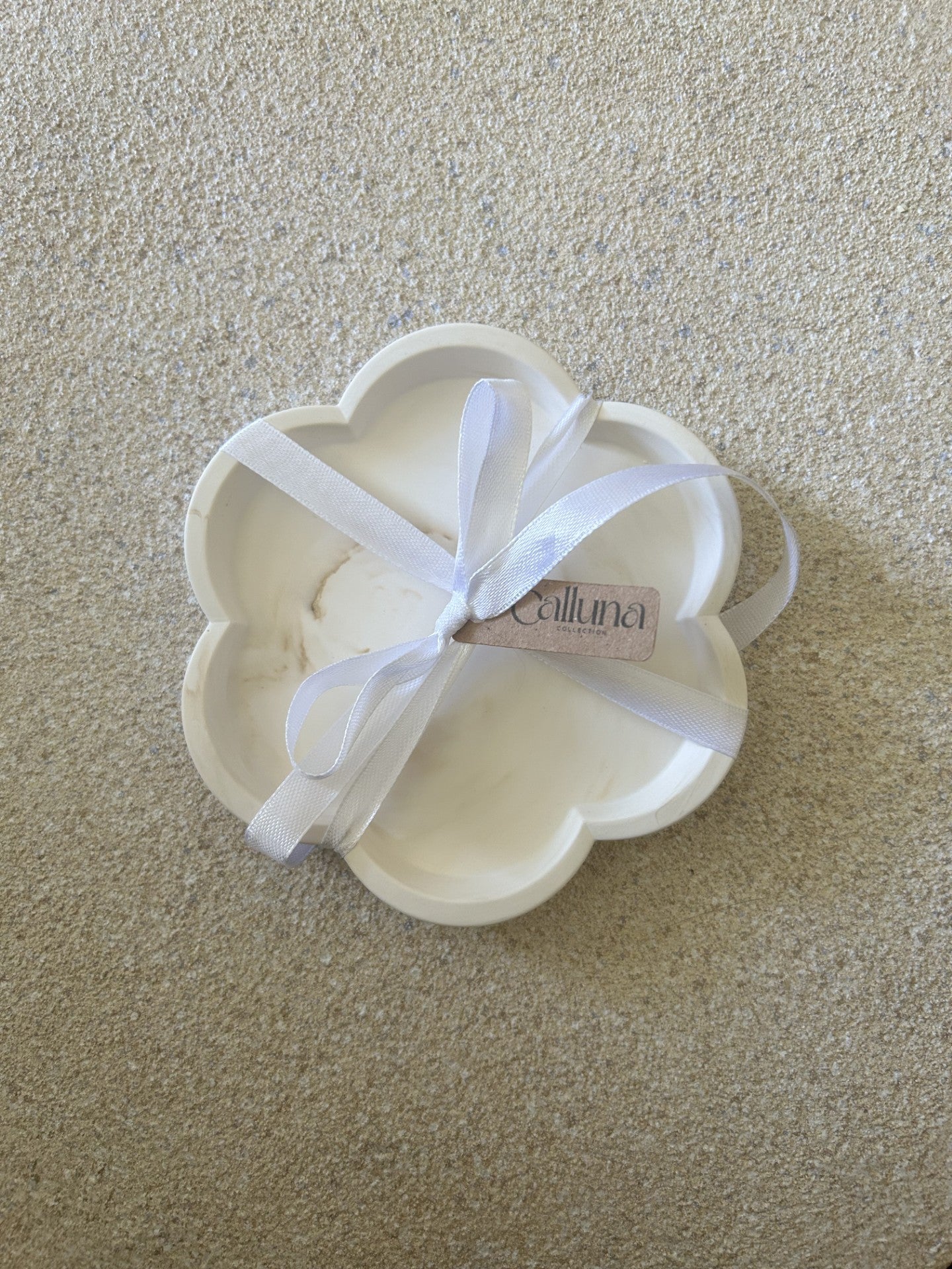 Handmade Home Accessories - a single brown marble flower candle dish with white ribbon around with a tag that says calluna