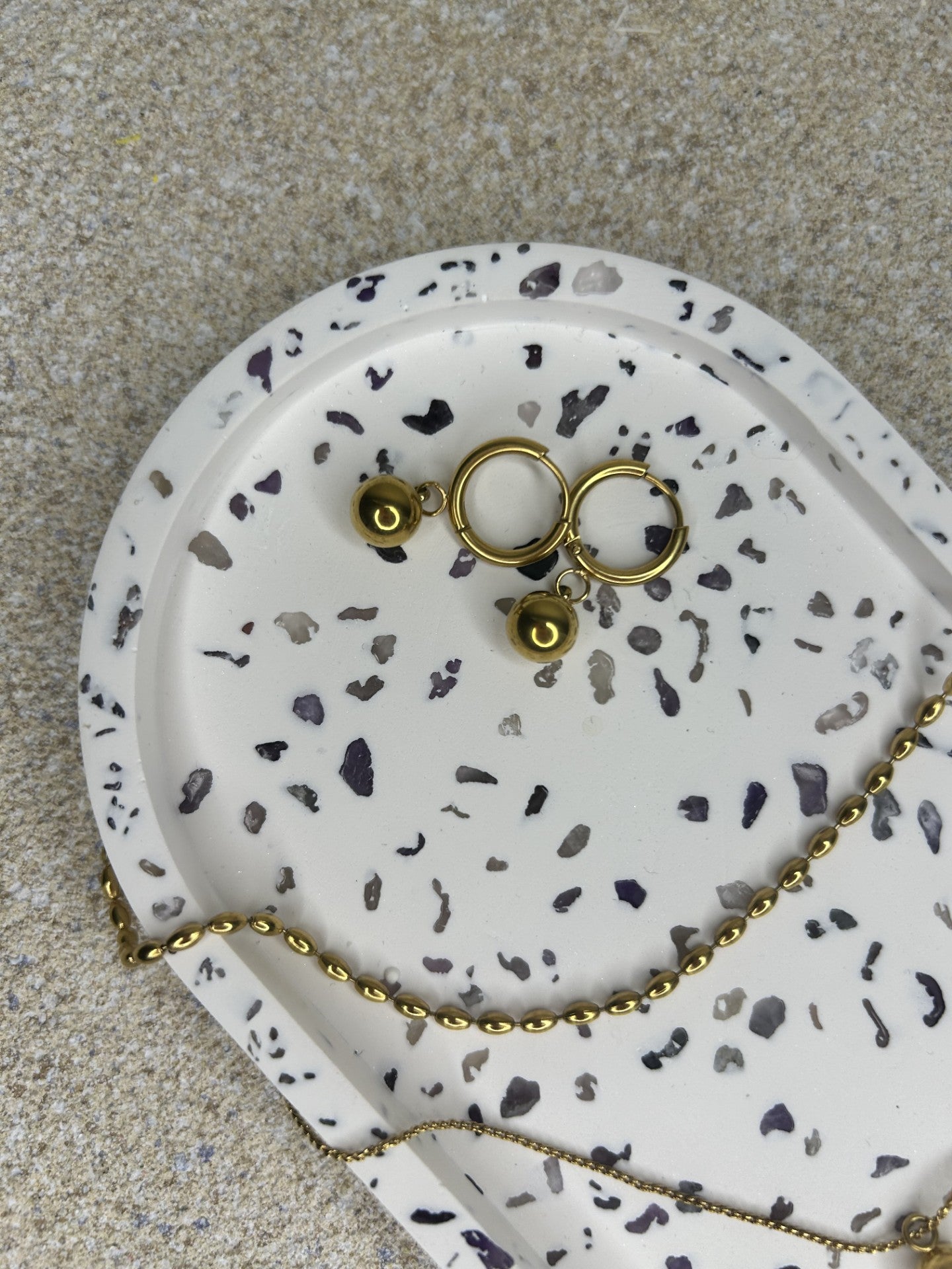Handmade Home Accessories - close up shot of an amethyst trinket tray with gold jewellery on