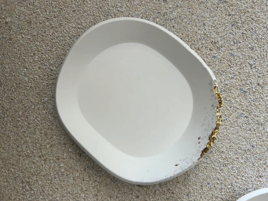 Handmade Home Accessories - A birds eye view shot of a white oval trinket dish, with a raw gold druzy edge.