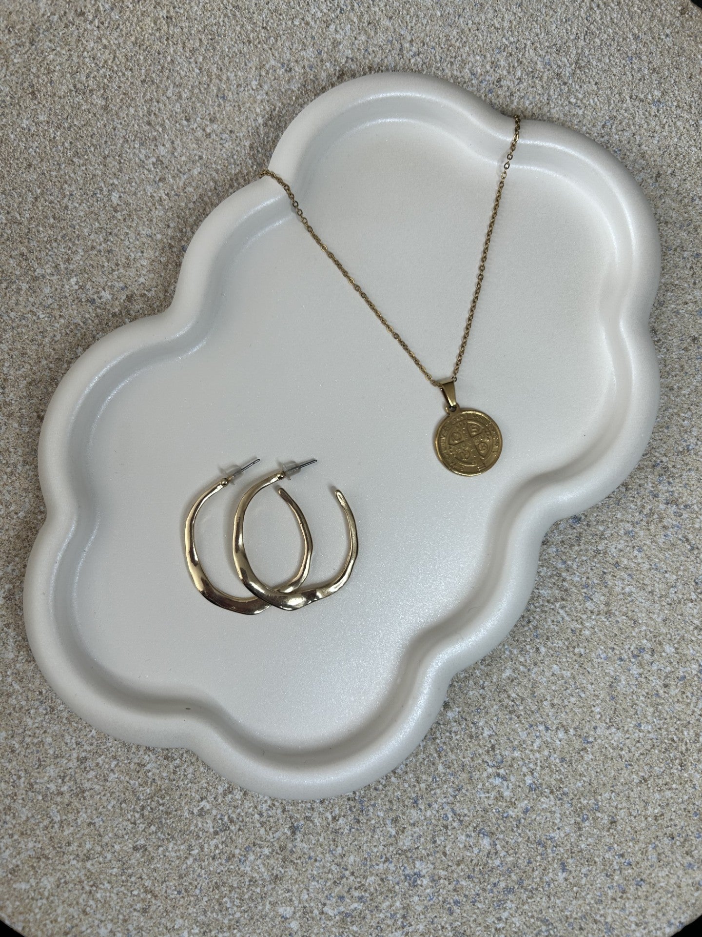 Handmade Home Accessories - Cloud Trinket Tray in a pearl white finish displaying a pair of gold earrings and a gold necklace. The photo is taken at a 45 degree angle and from birds eye view.