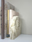 Handmade Luna Arch Bookend crafted from marbled cream and gold Jesmonite, styled beside neutral-toned design books including Gucci and Louis Vuitton, creating a serene and sophisticated shelf display.