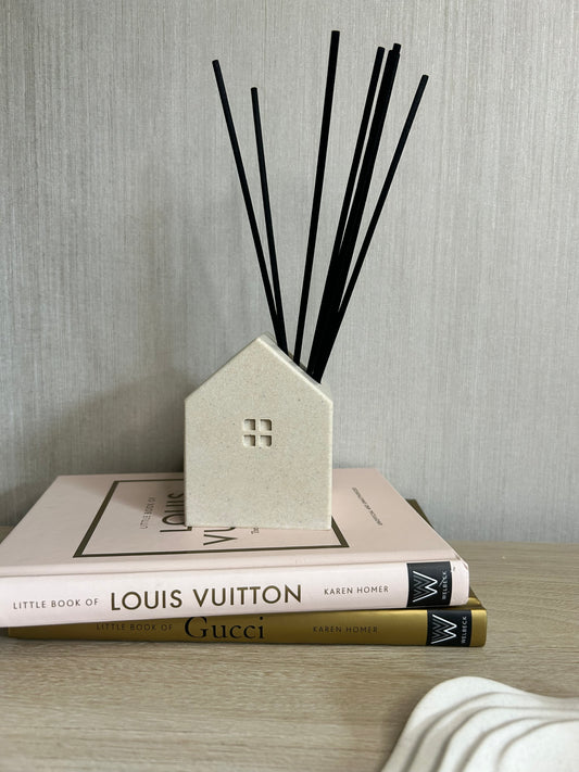 Handmade Home Accessories - A shot of a home reed diffuser of some books