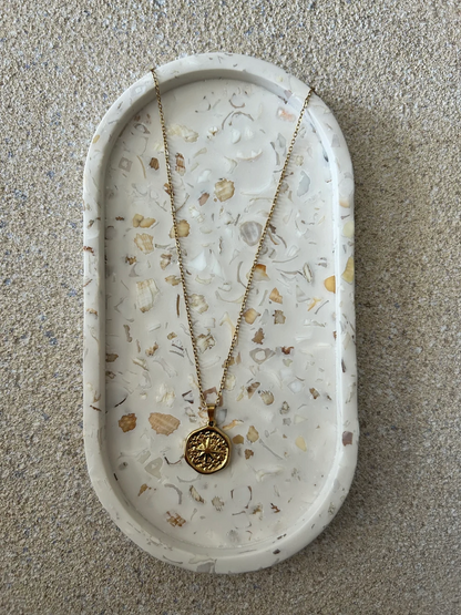 Handmade Home Accessories - A front on view of the oval seashell trinket tray, with a coin style gold chain on for display purposes.