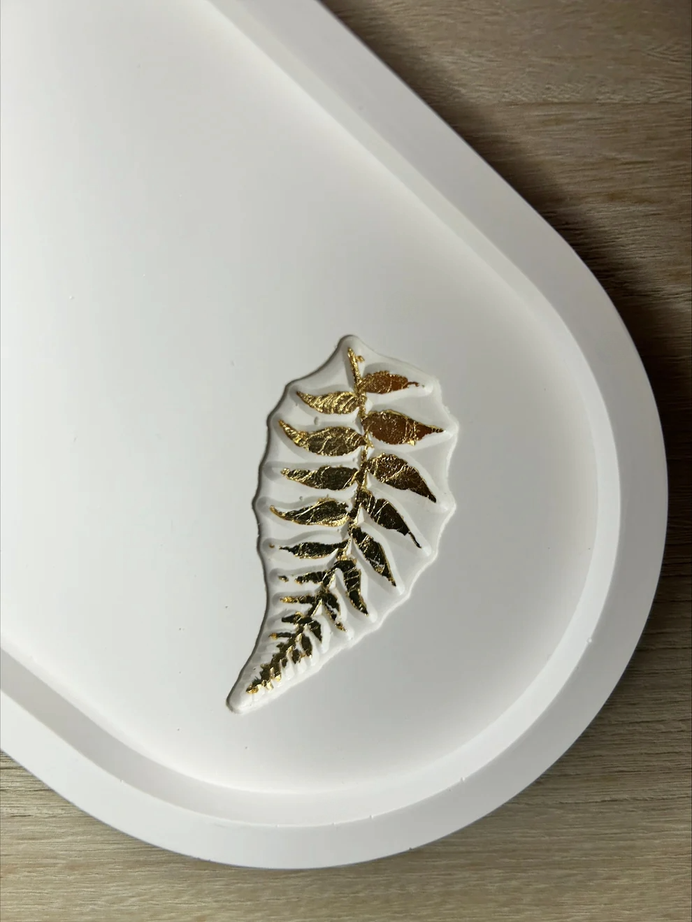 Handmade Home Accessories - A close up shot of a gold leaf detail fern inlay on a white trinket tray.