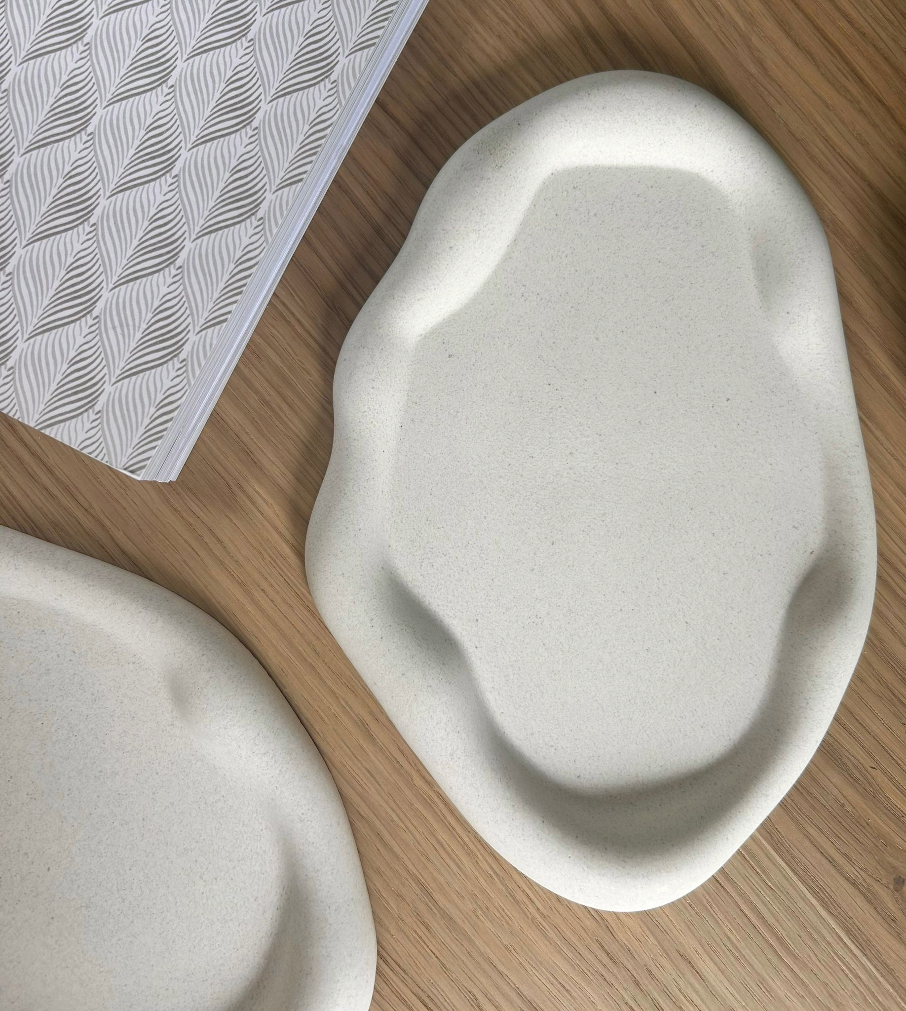 Artisan-crafted abstract ceramic tray with a soft matte finish, perfect as a decorative accent or functional piece for handmade home interiors.