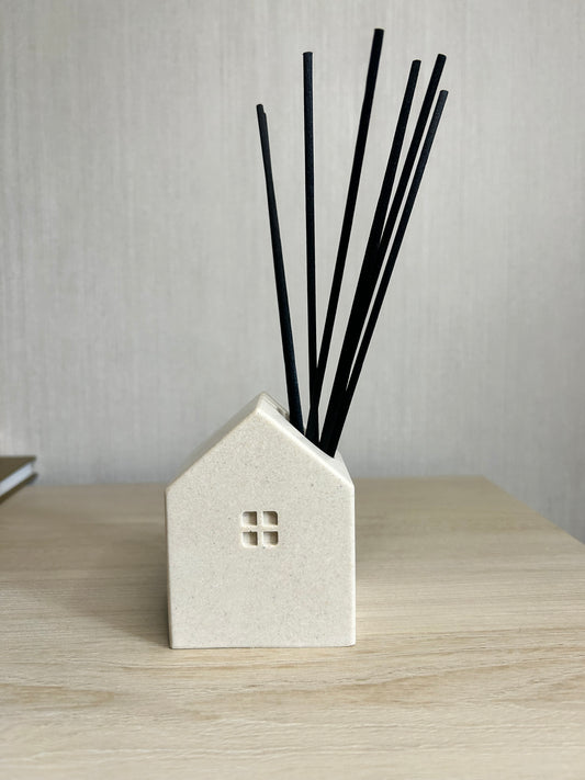 Handmade Home Accessories - A front on shot of a house shaped reed diffuser.