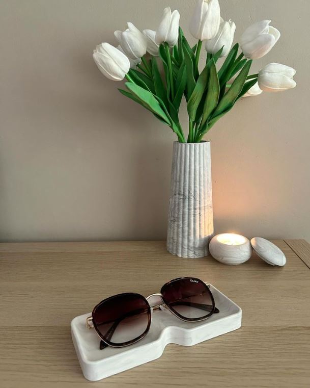 Handmade Home Accessories - Grey Marble Square glasses tray, on a wooden dresser with a pair of oversized sunglasses in. the background has a grey marble vase with white tulips in and a pot with a small lit candle.