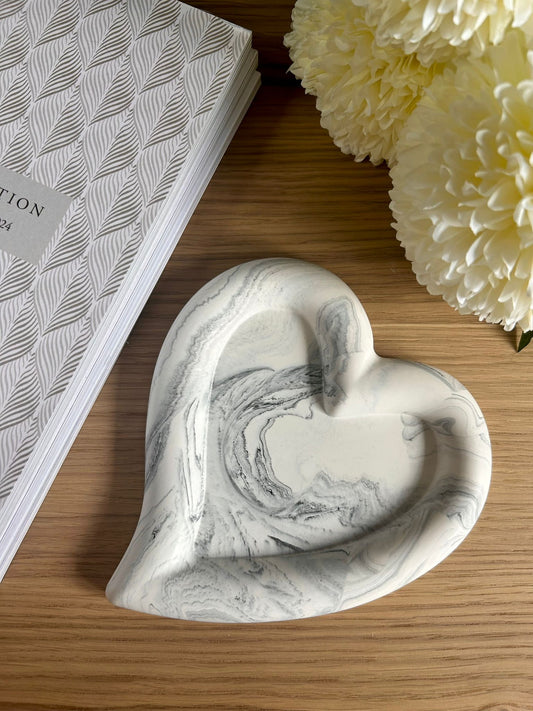 Handmade home accessory – grey marbled Jesmonite heart tray styled with soft florals and a textured journal. A perfect sustainable decor piece for jewellery or keys.