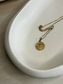Handmade Home Accessories - A close up shot of one side of the drift bowl that is displaying a gold coin necklace.