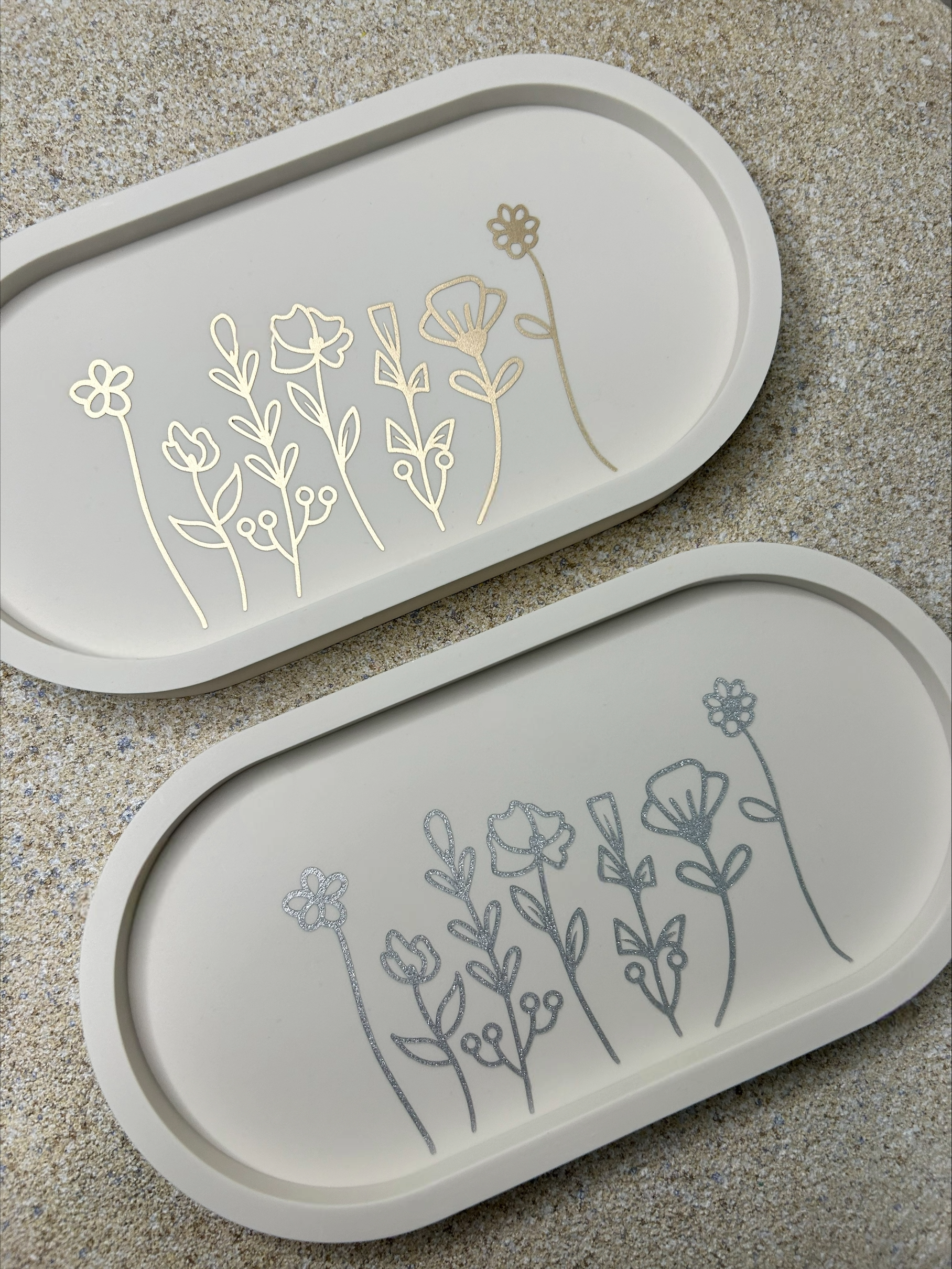 Handmade Home Accessories - two floral trinket trays, shot from  a birds eye view, one is silver and one is gold