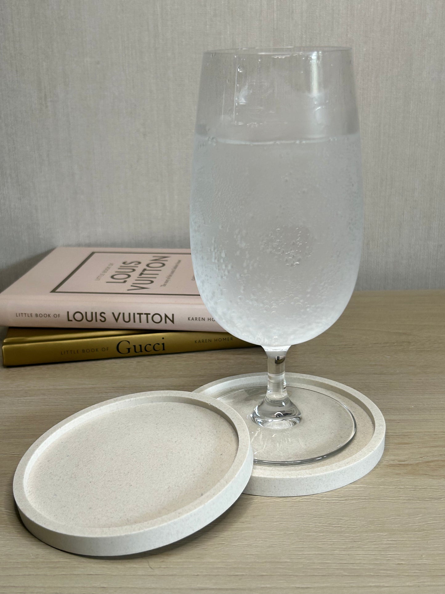 Handmade Home Accessories - A pair of Natural Stone Coasters with a drink displayed showing them in use.