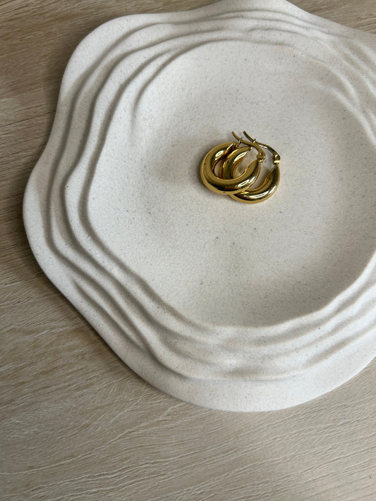 Handmade Home Accessories - The classic ripple candle dish, shown from a angle with gold earrings on.