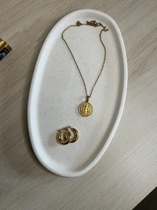 Handmade Home Accessories - A birds eye view of the curve oval trinket tray in a natural stone finish with gold jewelry displayed.