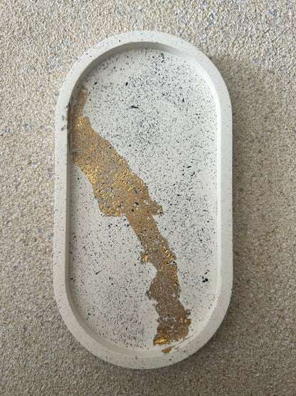 Handmade Home Accessories - Face on shot of the standard size trinket tray, its a cream colour with black splatters and gold leaf details running vertically down the front.