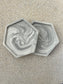 Handmade Home Accessories - Two grey marble hexagon shaped coasters, stacked on a natural textured stone backgorund