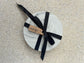 Handmade Home Accessories - One grey chunky coaster with a black ribbon around and a tag that says Calluna Collection.