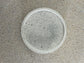 Handmade Home Accessories - A single white coaster thats round with black splatters all over it to give  speckled effect.