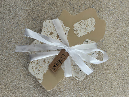 Handmade Home Accessories - a shot of the irregular coasters tied in a white bow with a Calluna Collection tag on to show how they are presented.