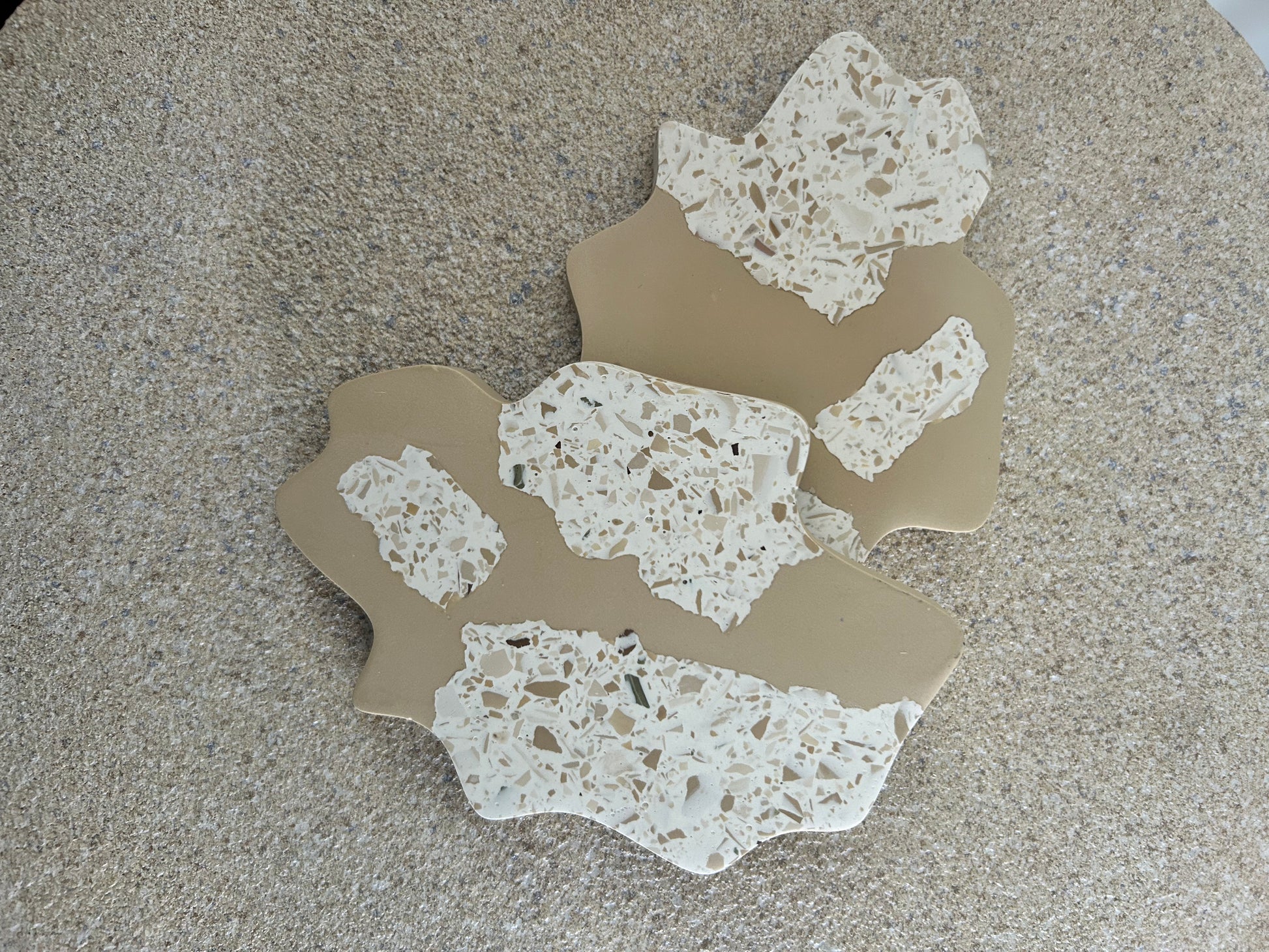 Handmade Home Accessories - handmade irregular shape coasters in beige and brown terrazzo in a snap style design.