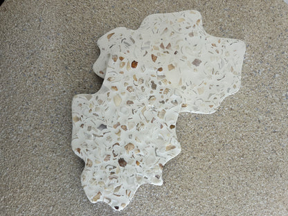 Handmade Home Accessories - A pair of irregular seashell terrazzo coasters on a natural stone background. 