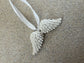 Handmade Home Accessories - a close up shot of a pair of angel wings on a white ribbon