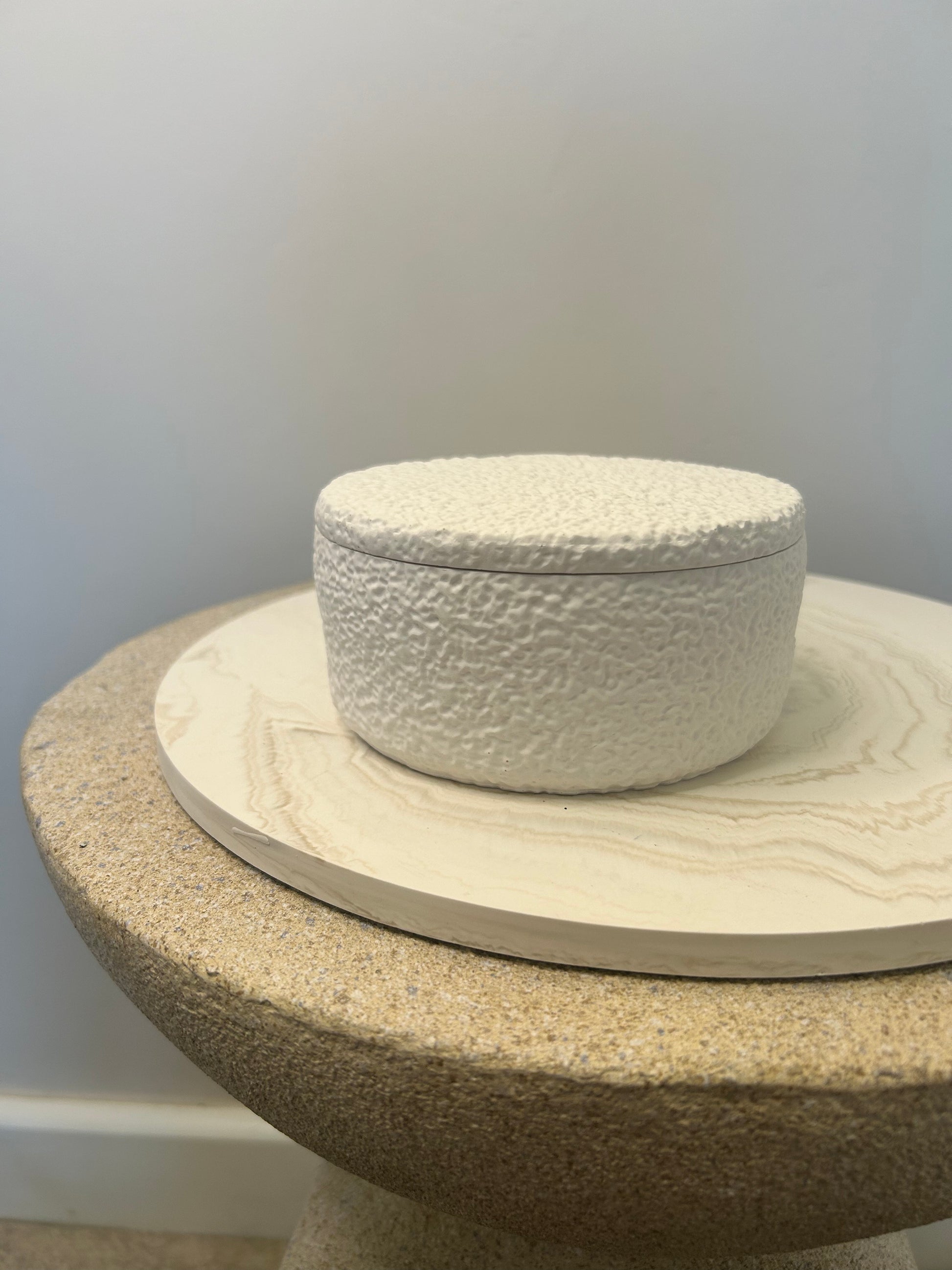 Handmade Home Accessories - a shot of a griege marble display plate with a teddy pot on, it is displayed of a stone effect table