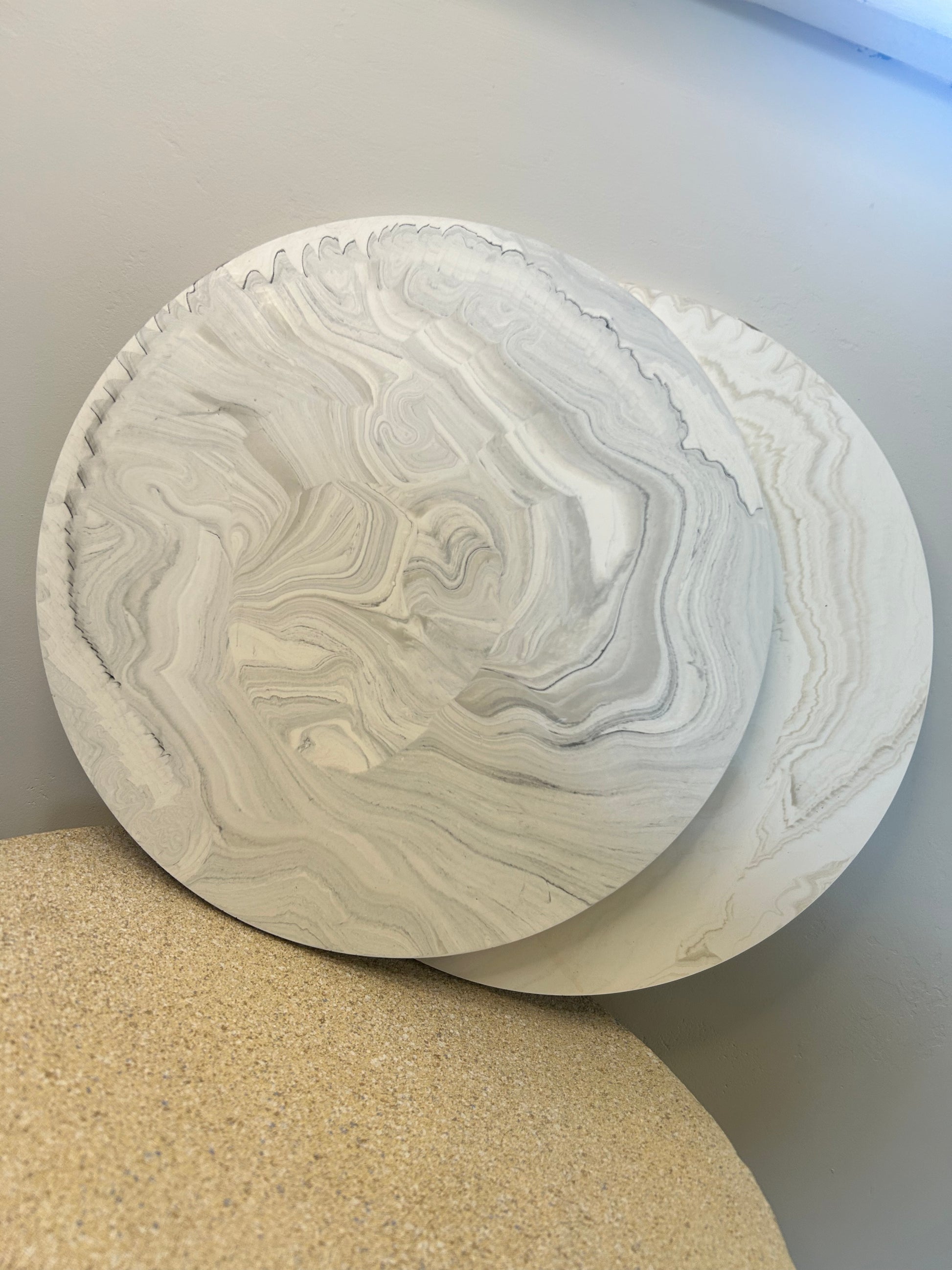 Handmade Home Accessories - a shot of two marble display plates, overlapping each other, one is grey and one is griege.