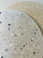 Handmade Home Accessories - a close up shot showing a grey terrazzo design with a beige terrazzo design int the background