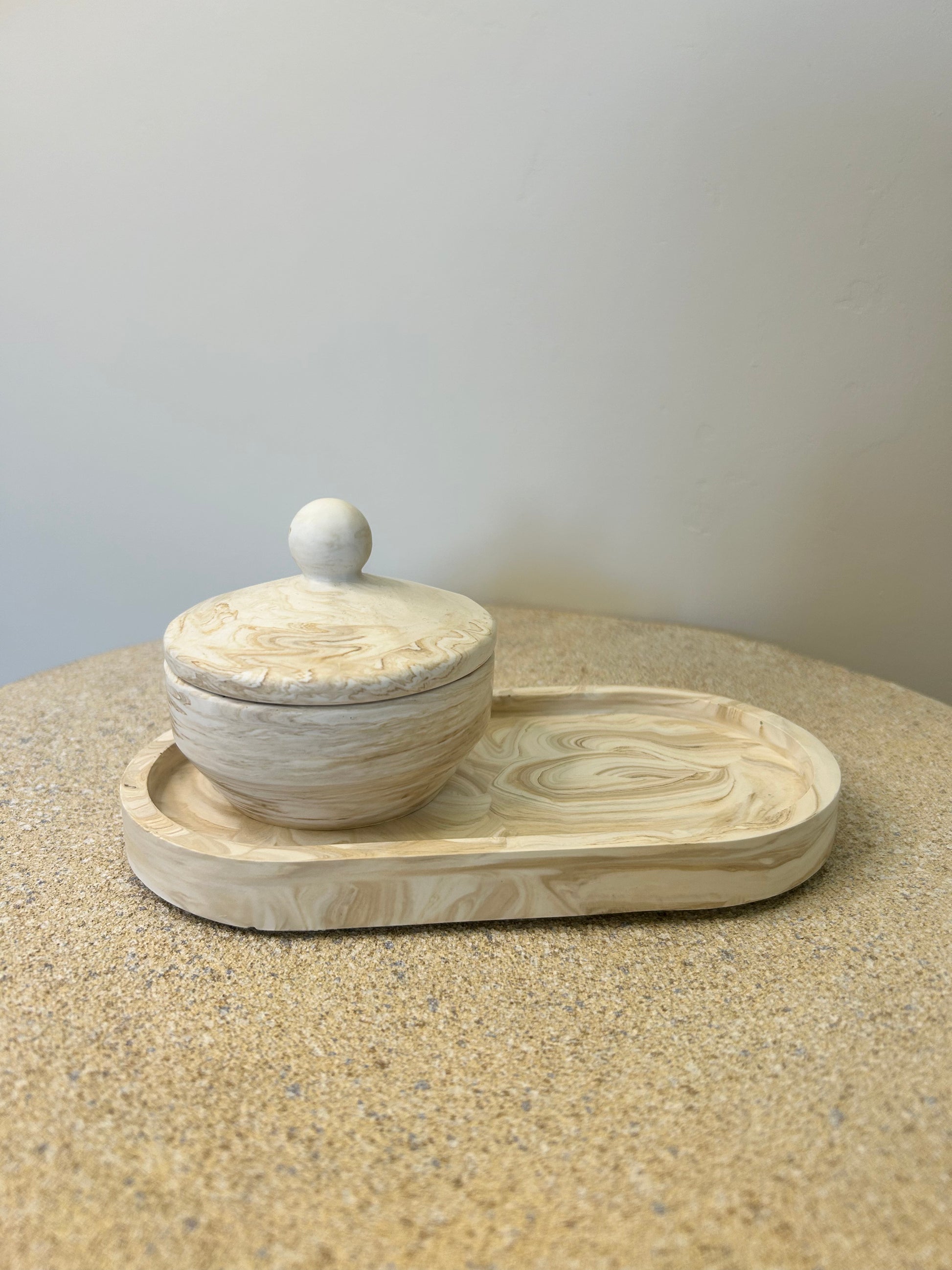 Handmade Home Accessories - a brown marble trinket pot on a brown marble trinket tray on a natural stone table