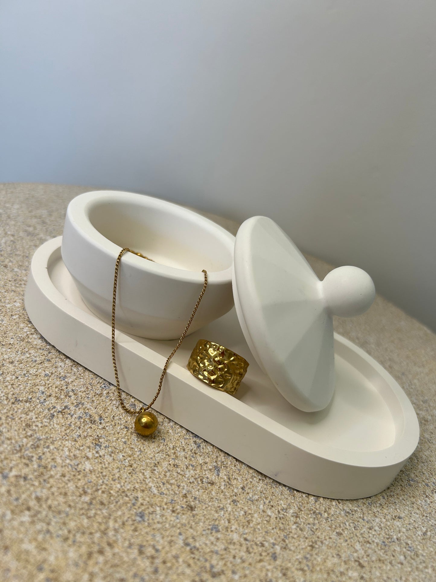 Handmade Home Accessories - a white trinket pot on a white trinket tray with gold jewellery added for display purposes.