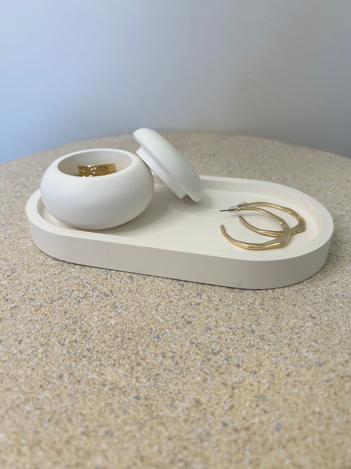 Handmade Home Accessories -  a white mushroom pot and white trinket tray with gold jewellery displayed on them