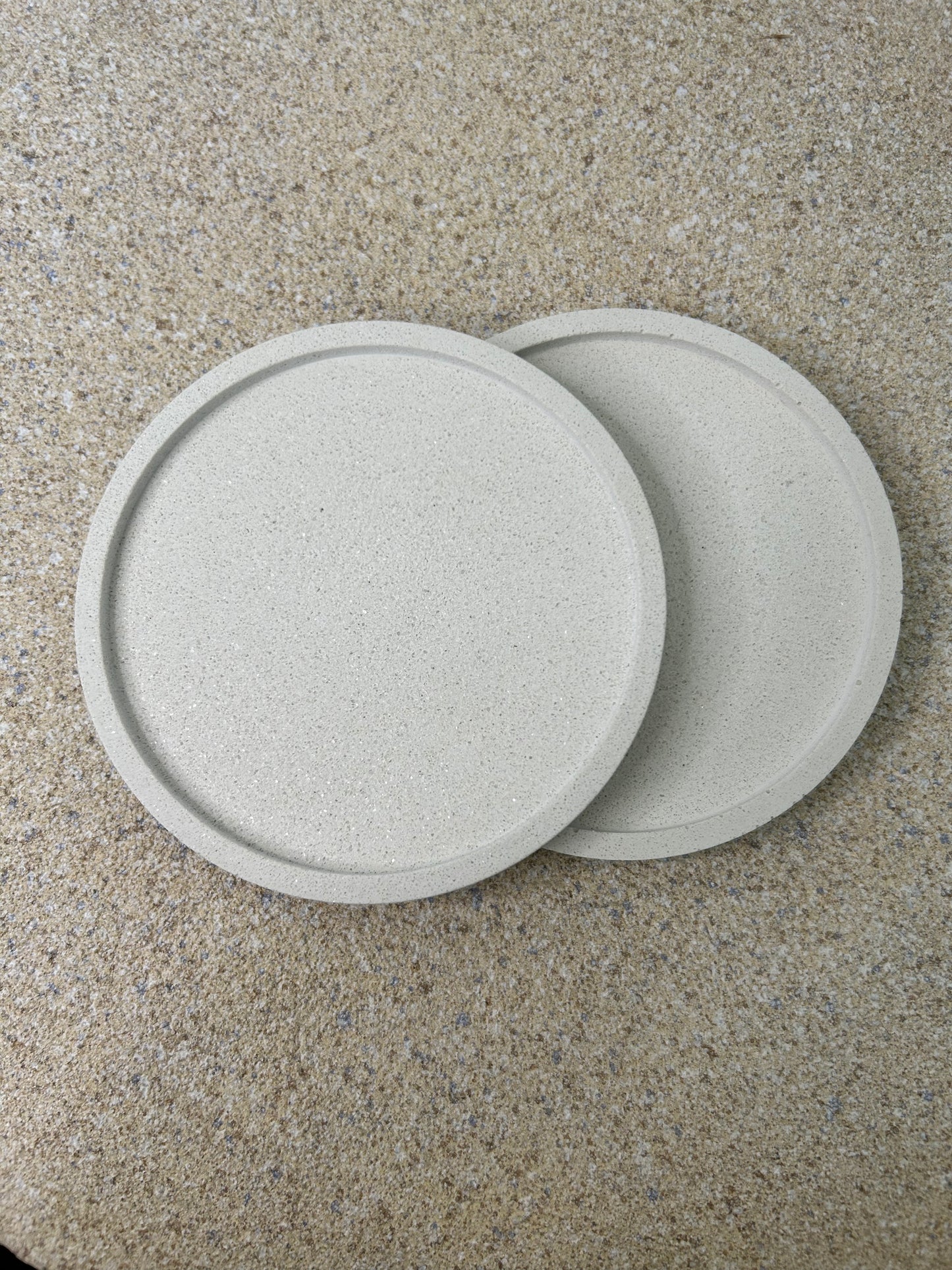 Handmade Home Accessories - two white marble roound coasters on a natural stone background