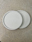 Handmade Home Accessories - two white marble roound coasters on a natural stone background