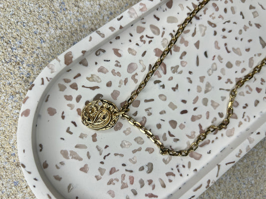 Handmade Home Accessories - a zoomed in shot of a rose quartz trinket tray displaying a gold necklace.