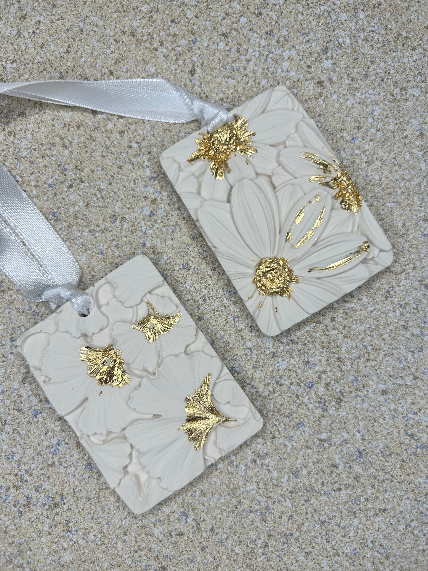 Handmade Homes Accessories - two off white aromatherapy pebbles with a floral design with gold touches