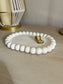 Handmade Home Accessories - An angled shot of the bubble trinket tray showing its depth with gold rings on.