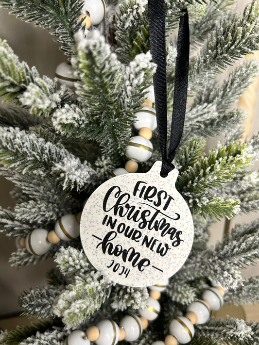 Handmade Christmas Decor - First Christmas in our new home bauble in black sparkling writing on a christmas tree.