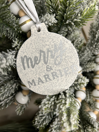 Handmade Christmas Decor - Merry and married bauble with silver sparkling writing, showing it catching the light.