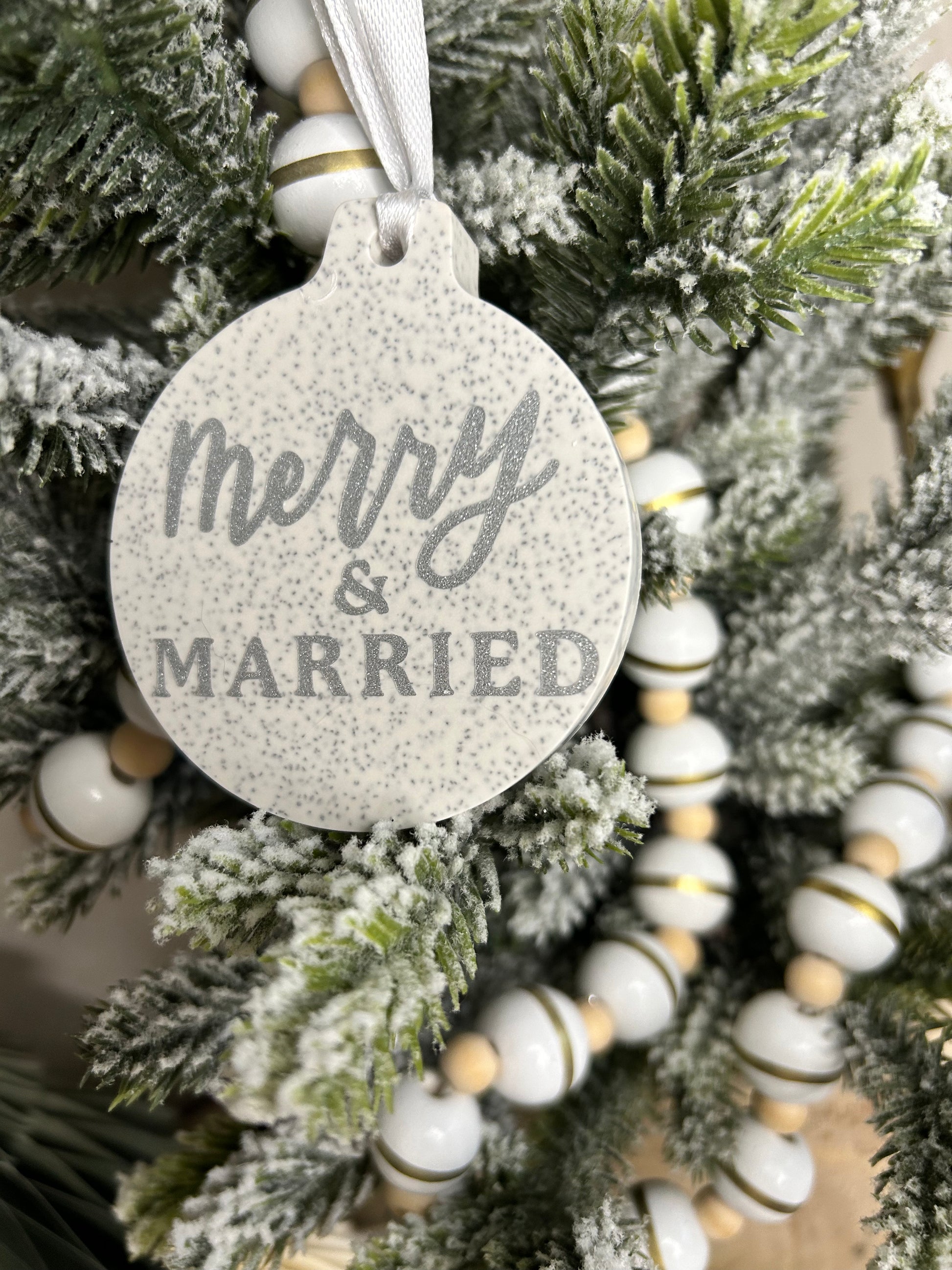 Handmade Christmas Decor - Merry and married bauble with silver sparkling writing on a christmas tree.