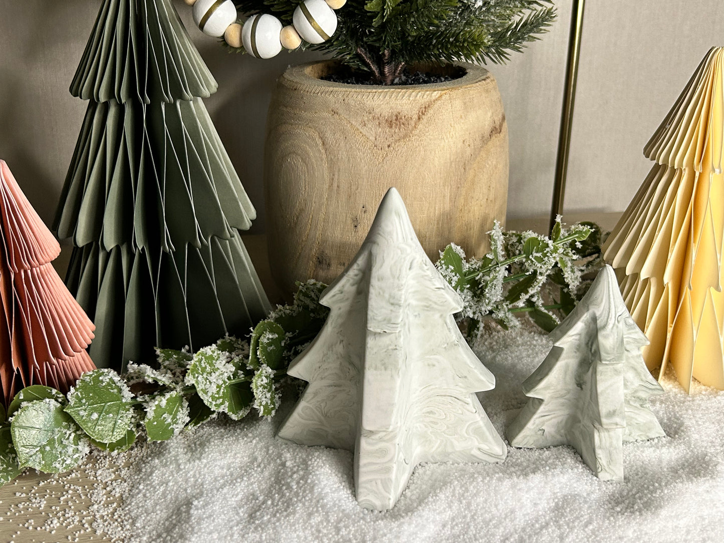 Handmade Home Accessories - A shot of green marble christmas tree ornaments set up in a festive neutral christmas scene