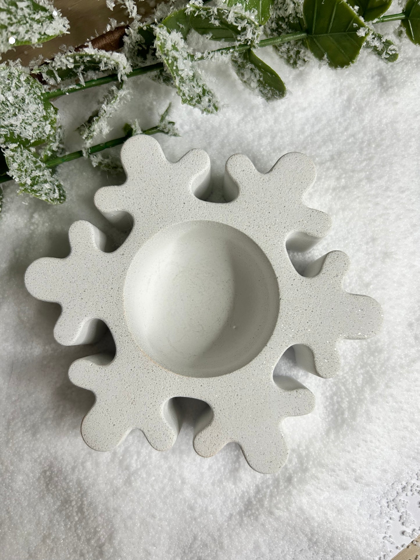 Handmade Christmas Decor - Sparkling white marble snowflake candle holder from a birds eye view.