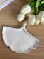 Handmade home accessory – ceramic leaf-shaped tray with textured detail, styled beside white tulips. A sustainable and elegant addition to modern decor.