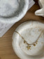 Two marbled decorative trays with gold starfish necklace – bespoke handmade home accessories with coastal tones.