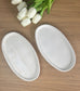 Set of white and marbled oval trinket dishes displayed with tulips, capturing the essence of handmade home accessories for modern interiors.