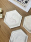Flat lay of handmade Jesmonite hex trays in rose, cream and grey marbling. Sculptural, eco-friendly home accessories designed for everyday use.