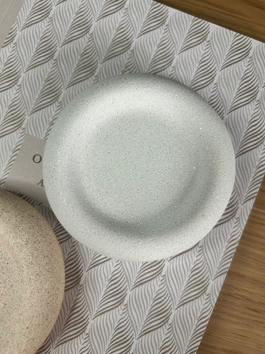 Close-up of a round white marble Jesmonite tray with a smooth, tactile finish. A sustainable handmade home accessory perfect for jewellery, keys, or trinkets.