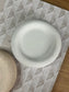 Close-up of a round white marble Jesmonite tray with a smooth, tactile finish. A sustainable handmade home accessory perfect for jewellery, keys, or trinkets.