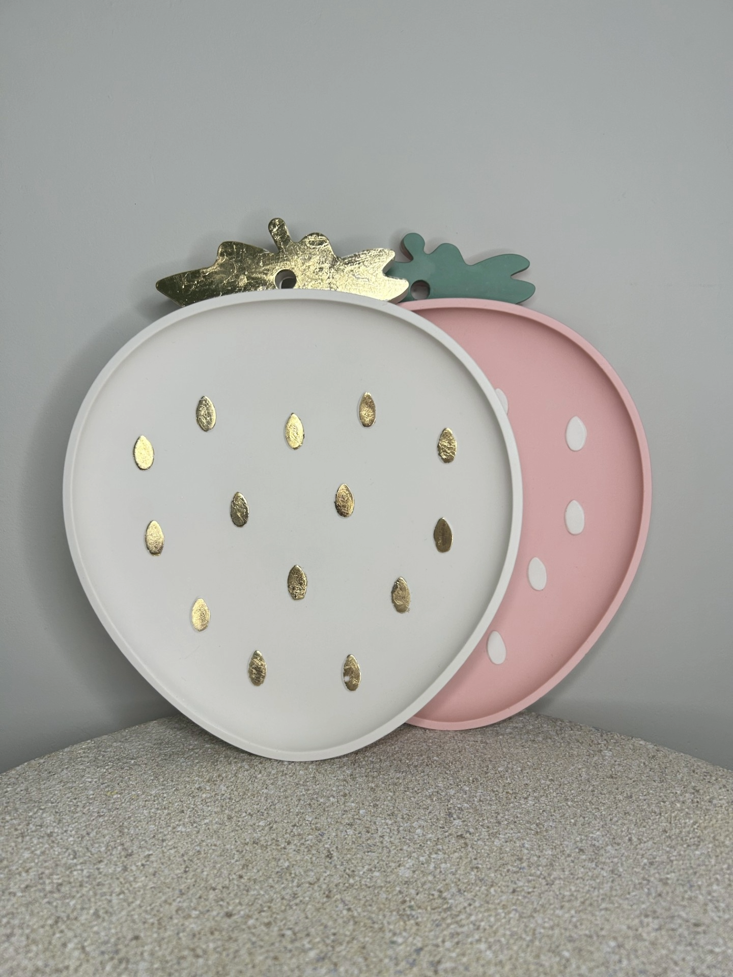 Handmade Homes Accessories - two strawberry trinket trays stacked against a neutral wall, one pink and one cream and gold